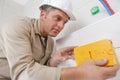 Male worker grouting tiles Royalty Free Stock Photo