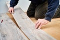 Male worker hands laying laminate flooring in apartment. Royalty Free Stock Photo