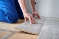 Male worker hands laying laminate flooring in apartment. Royalty Free Stock Photo