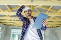 male worker holding clipboard checking wood beams Royalty Free Stock Photo