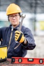 Male worker holding wrench at construction site Royalty Free Stock Photo