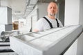 A male worker holds an air filter for air conditioning in an office space. Installation of an air conditioner. Royalty Free Stock Photo