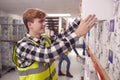 Male Worker Inside Busy Warehouse Putting Box Onto Shelf Royalty Free Stock Photo