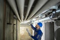 Male Worker Inspecting Pipes