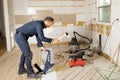 A Male Worker install wood floor on a house