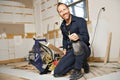 A Male Worker install wood floor on a house