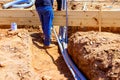 Male worker installing electrical conduits at construction site outdoors Royalty Free Stock Photo