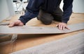 Male worker installing laminate floor in apartment. Royalty Free Stock Photo