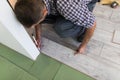 Male worker installing laminate flooring, man installing new wooden laminate flooring. Man laying laminate flooring at home. Carpe Royalty Free Stock Photo