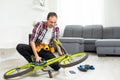 Male worker at the machine tool checks bicycle rim Royalty Free Stock Photo