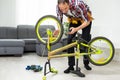 Male worker at the machine tool checks bicycle rim Royalty Free Stock Photo