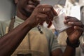 Male Worker Opening Coffee Drip Bag Inspecting Production at Food Factory