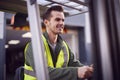 Male Worker Operating Fork Lift Truck At Freight Haulage Business