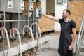 Man operating milking machine at the goat farm Royalty Free Stock Photo