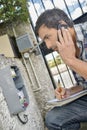 male worker on phone repairing gate