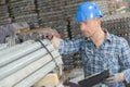 Male worker and pipe inventory Royalty Free Stock Photo