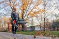 Male worker with portable leaf blower in sunny morning. Royalty Free Stock Photo