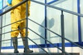 Male worker in protective suit spraying insecticide on stairs outdoors, closeup. Pest control Royalty Free Stock Photo