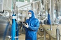 Male worker in protective suit using digital tablet Royalty Free Stock Photo