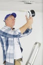 male worker removing ceiling air filter Royalty Free Stock Photo