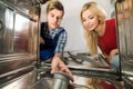 Male Worker Repairing Dishwasher In Kitchen Royalty Free Stock Photo