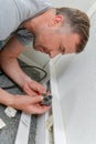 male worker repairing mains plug