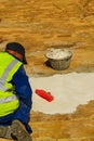 Male worker restores tiled patio terrace