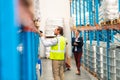 Male worker scanning package with barcode scanner in modern warehouse