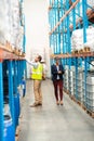 Male worker scanning package with barcode scanner in modern warehouse