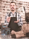 Male worker showing key he made in repair workshop Royalty Free Stock Photo