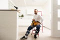 Male Worker Sitting on the Ladder on Construction Site. Repair Home and House Renovation Service Royalty Free Stock Photo