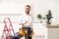 Male Worker Sitting on the Ladder on Construction Site. Repair Home and House Renovation Service Royalty Free Stock Photo