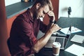 Young man getting tired of working in the office