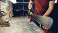 Male worker of ski service workshop doing sharpening and repair of skis. Sharpening ski edges with a manual side-edge tuning tool