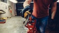 Male worker of ski service workshop doing sharpening and repair of skis. Sharpening ski edges with a manual side-edge tuning tool Royalty Free Stock Photo