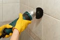 Male worker tiling a wall.