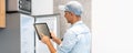 Male worker types on a tablet, kitchen renovation Royalty Free Stock Photo