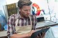 male worker using tablet in workshop Royalty Free Stock Photo