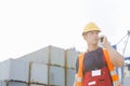 Male worker using walkie-talkie in shipping yard Royalty Free Stock Photo
