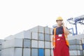 Male worker using walkie-talkie in shipping yard Royalty Free Stock Photo