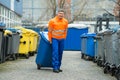 Male Worker Walking With Dustbin On Street Royalty Free Stock Photo