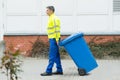 Male Worker Walking With Dustbin On Street Royalty Free Stock Photo