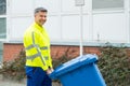 Male Worker Walking With Dustbin On Street Royalty Free Stock Photo