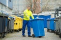 Male Worker Walking With Dustbin On Street Royalty Free Stock Photo
