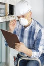 Male worker wearing mask writing notes Royalty Free Stock Photo