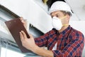 male worker wearing mask writing notes Royalty Free Stock Photo