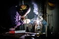 Welder at work in industrial environment