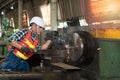 Male worker working on a lathe machine in metal industry factory on a business day Royalty Free Stock Photo