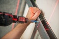 Male worker works with profile for drywall, setting, assembling with drill. Construction work, repair. Royalty Free Stock Photo