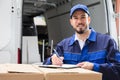 Male Worker Writing On Clipboard Royalty Free Stock Photo